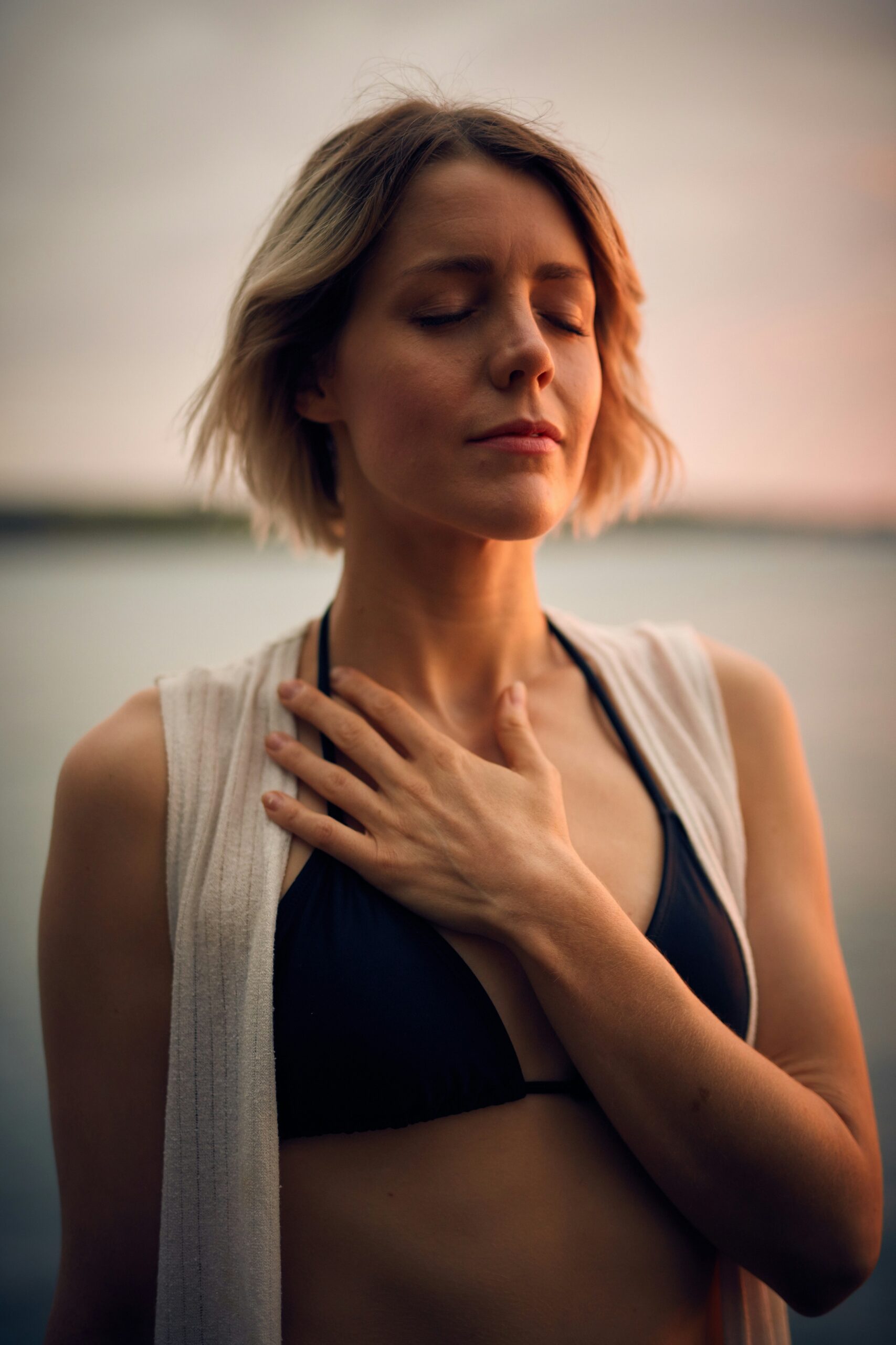 Woman with her hand on her heart breathing deeply